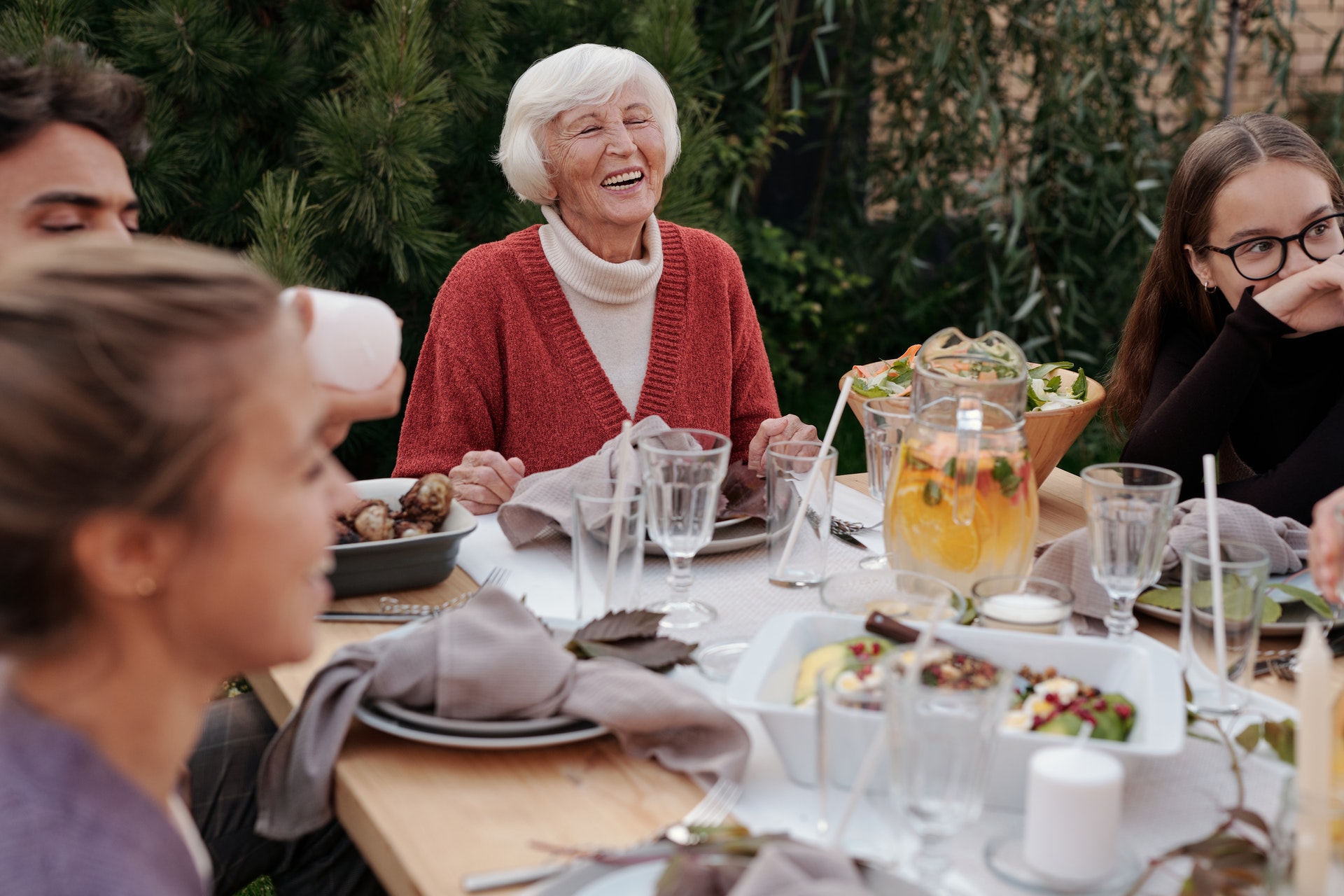 Group eating together including and elderly lady